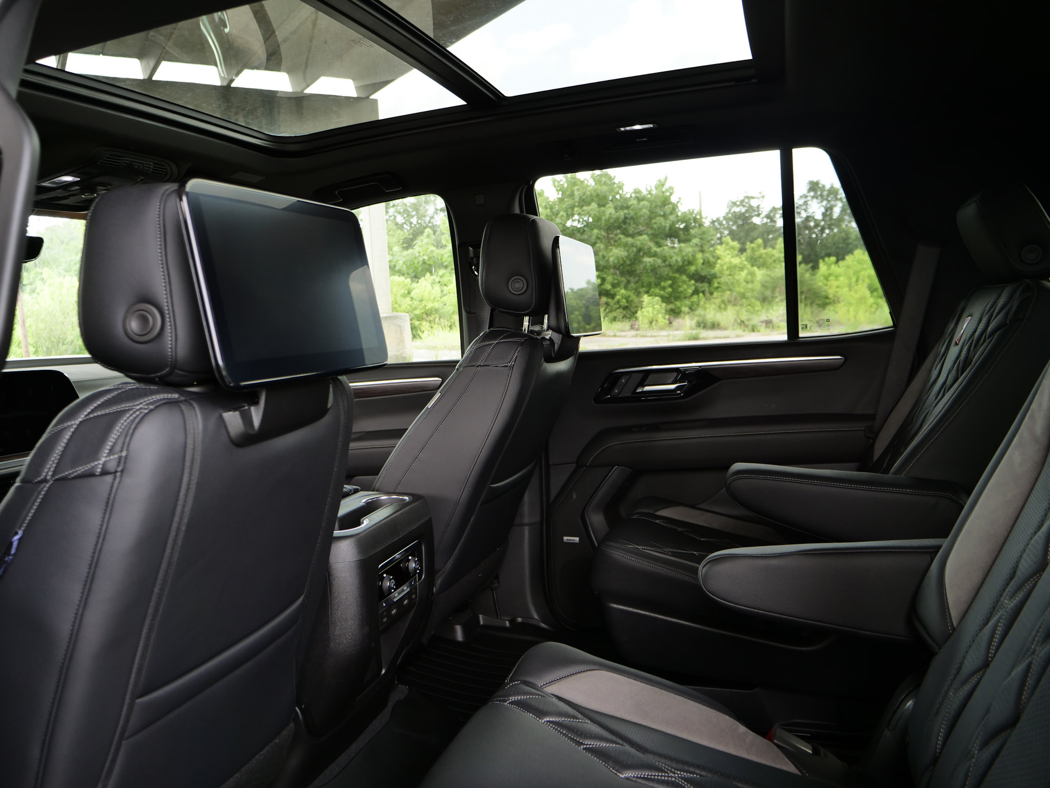 Woman enjoying the view of a lifted silverado Black Widow truck.
