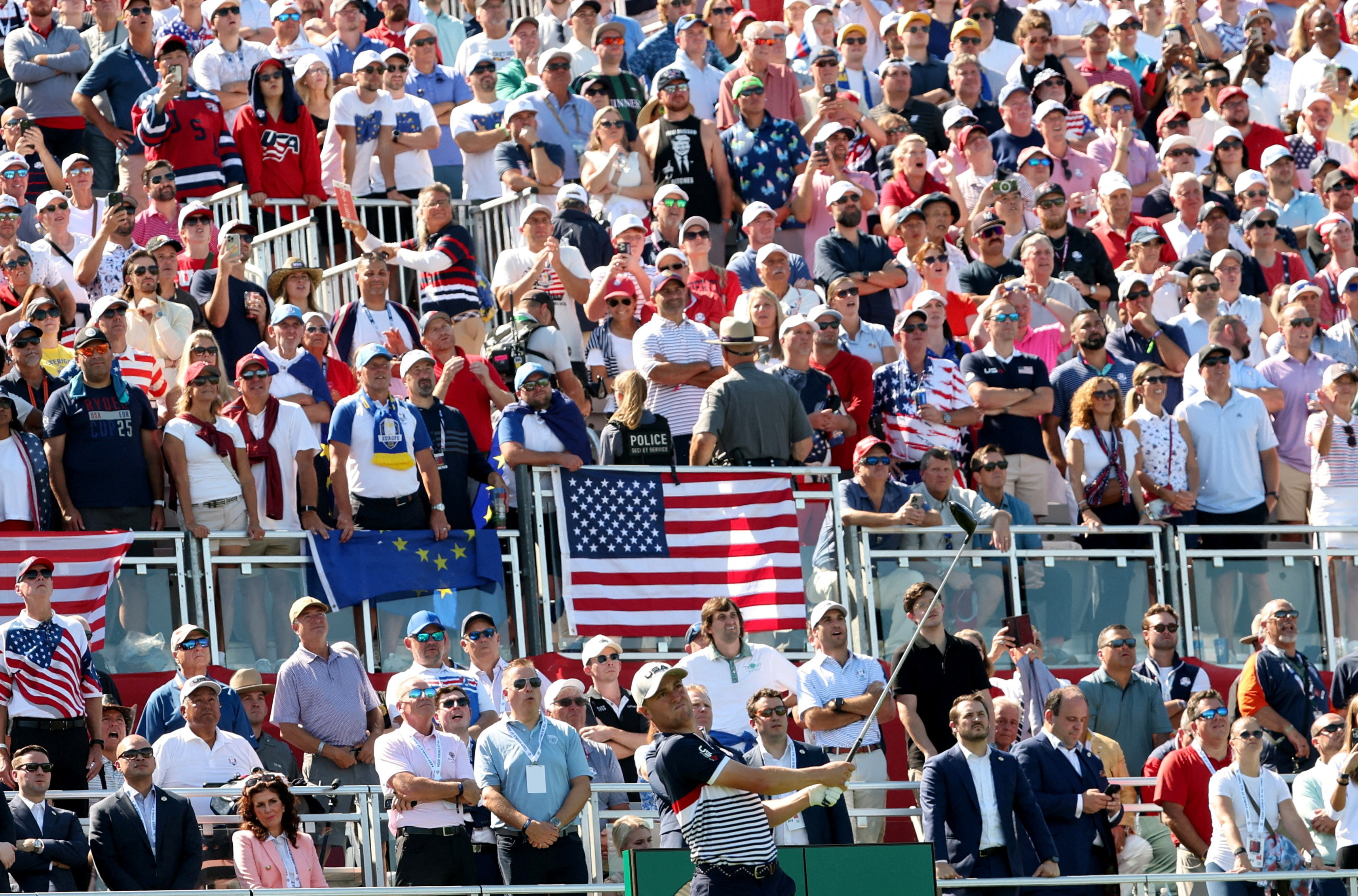 Golf ball and golf club in a beautiful golf course at sunset background. Collection of golf equipment resting on green grass with green background