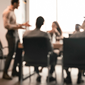 Meeting in boardroom with men and women