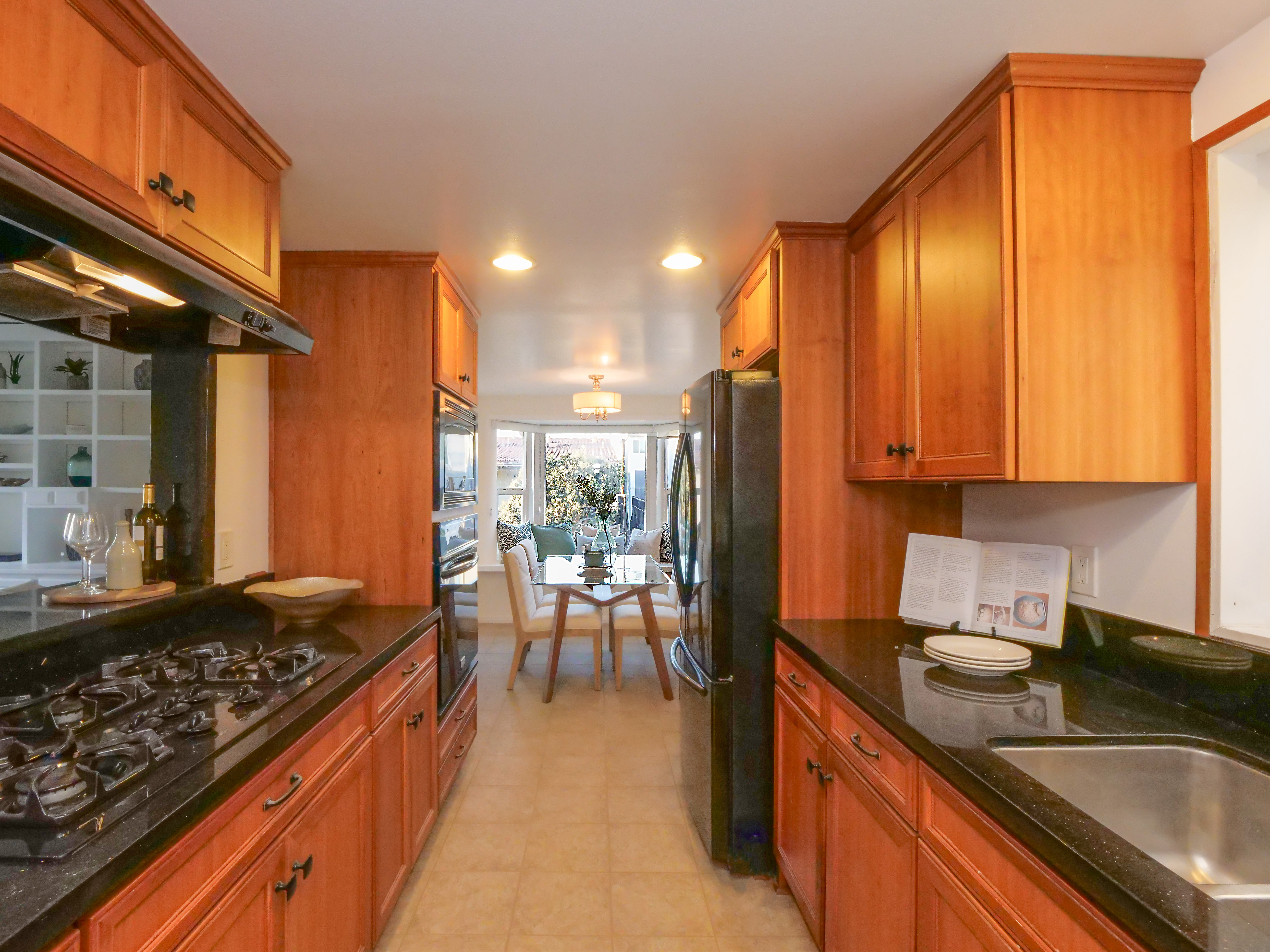 Happy young interracial couple shake hand of bank manager broker buy insurance services take mortgage loan, mixed ethnicity customers handshake agent make agreement financial business deal at meeting