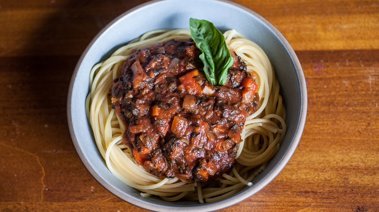 Older adult gratefully receiving a crate full of healthy food from a meal program. 