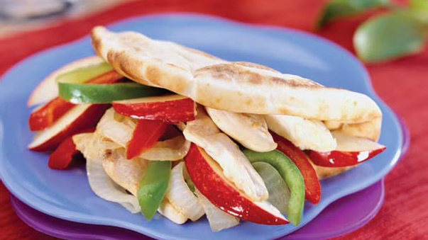 Older adult gratefully receiving a crate full of healthy food from a meal program. 
