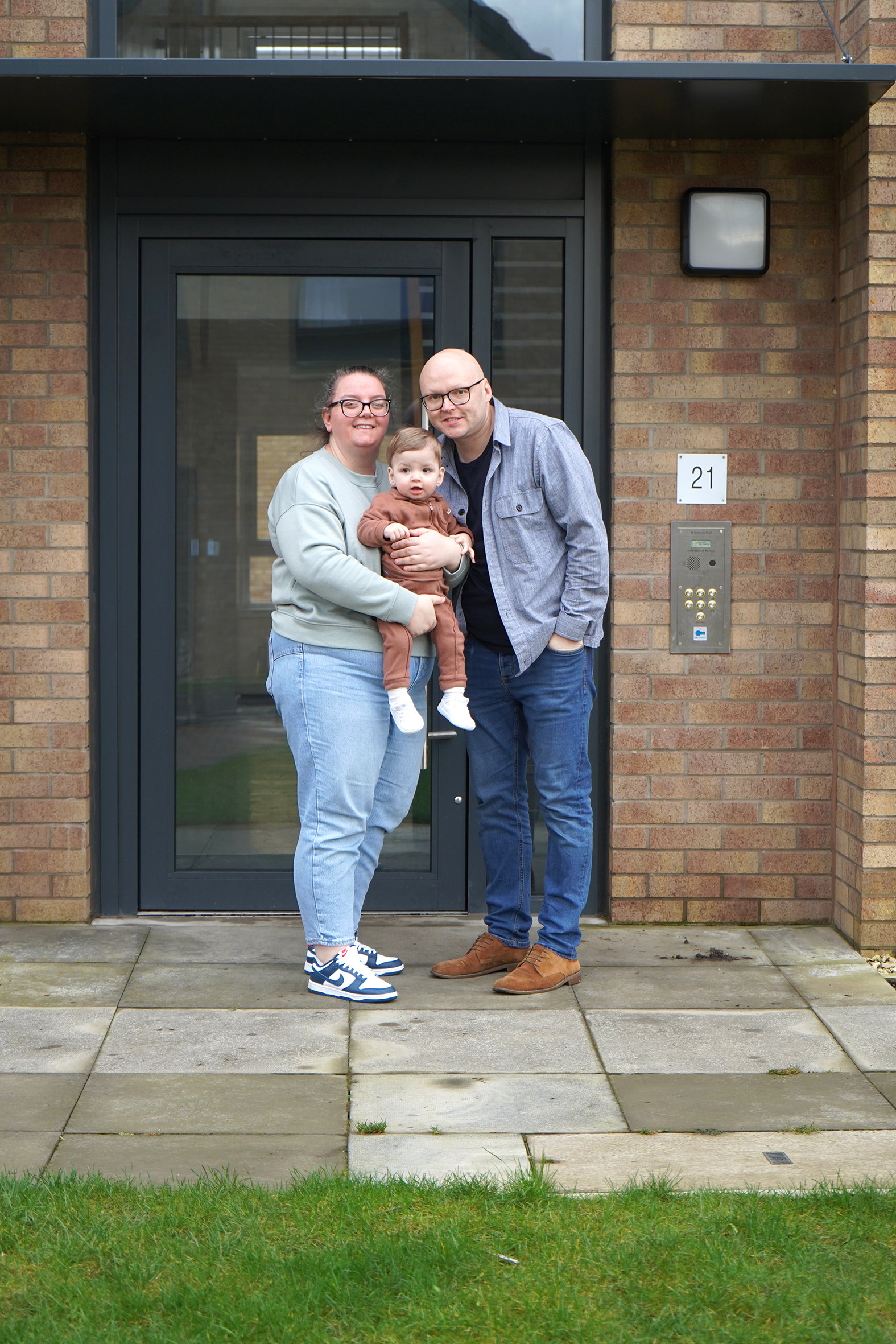 Photo of Home Group customers, a man women and child outside their home