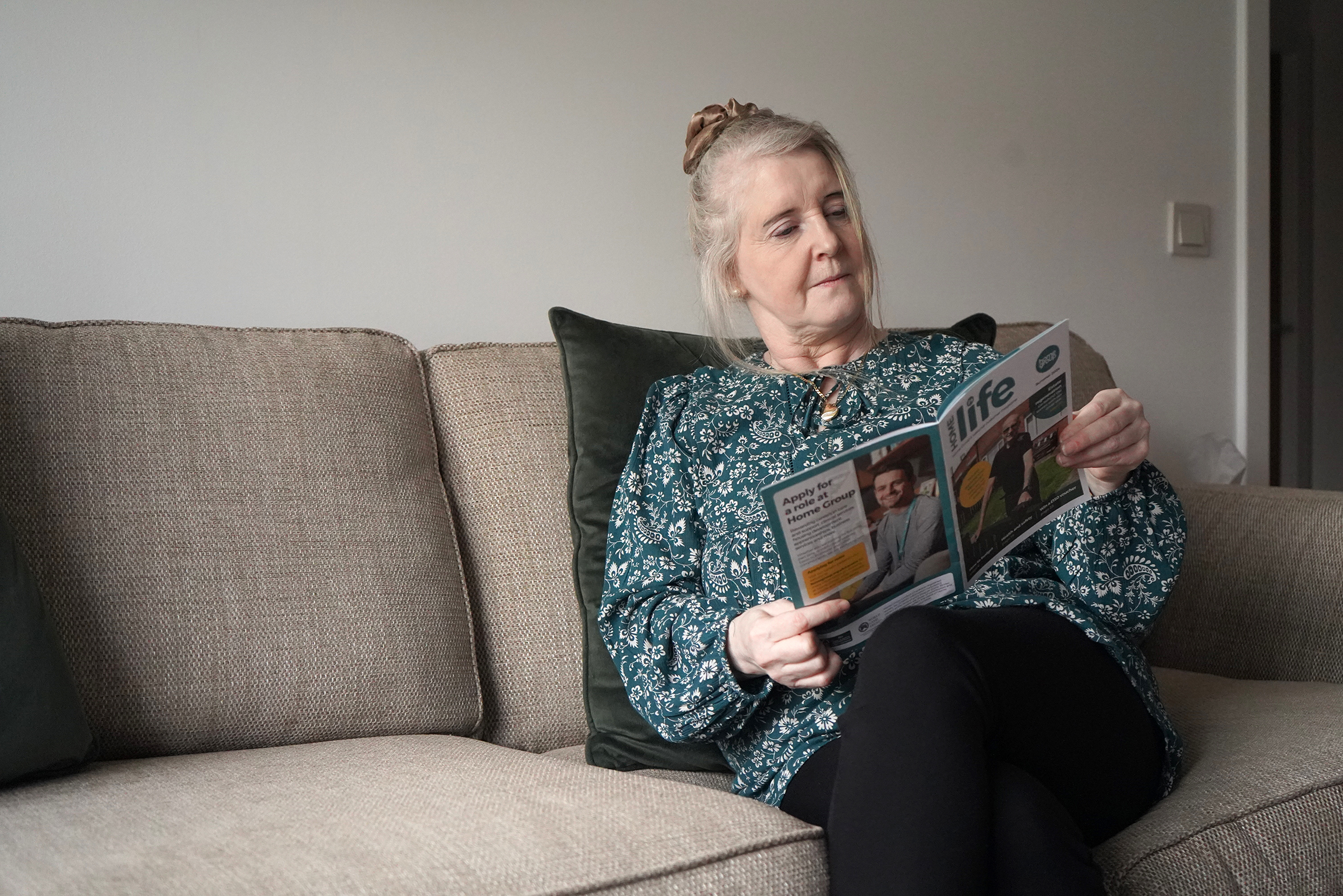 Photo of a Home Group customer reading Homelife magazine