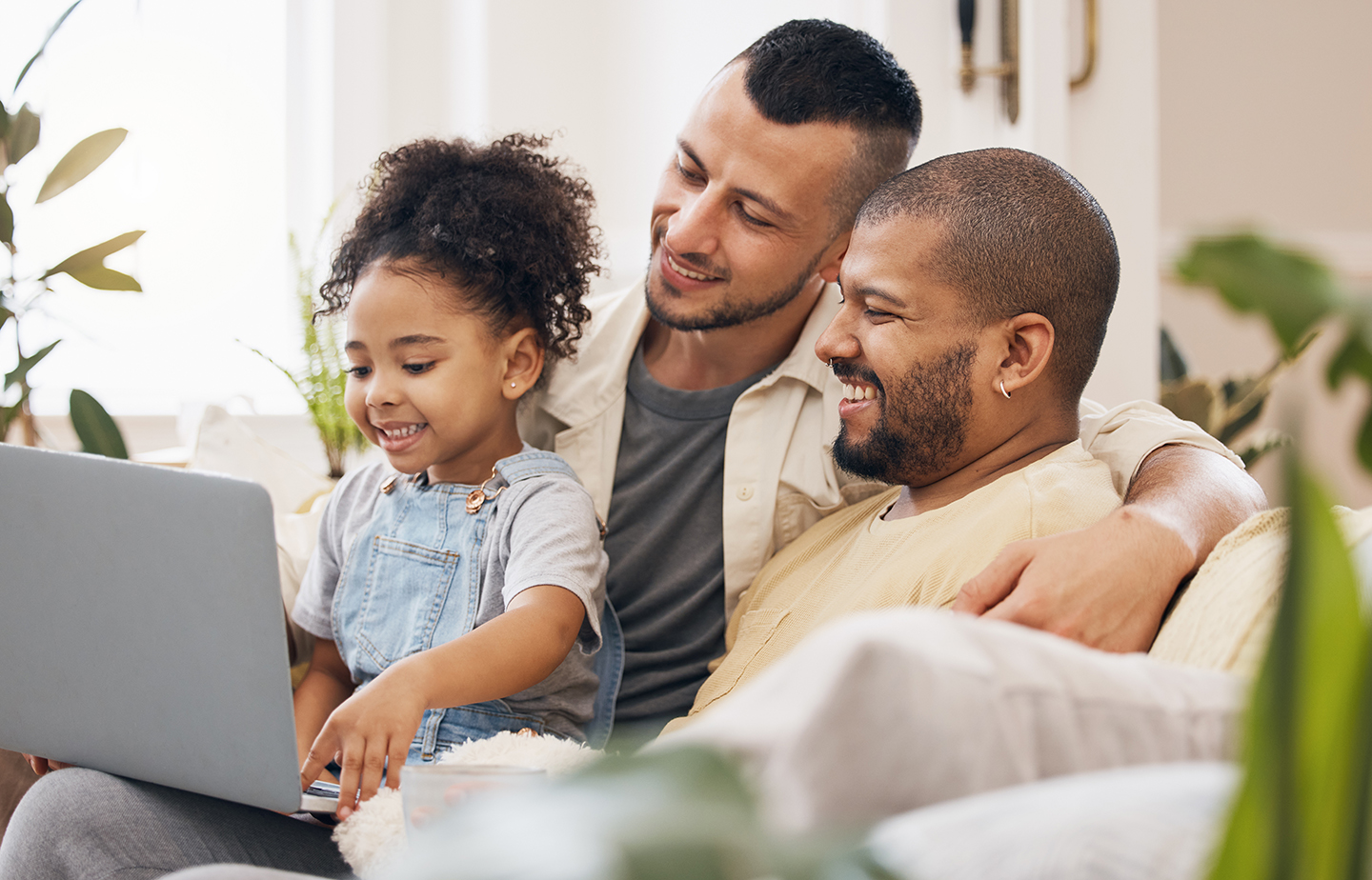 dads with female child, kid and pc for cartoon or film in the living room.