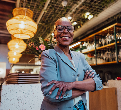 confident business woman with arms crossed smiling at the camera.