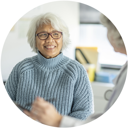 Smiling woman wearing glasses and sweater