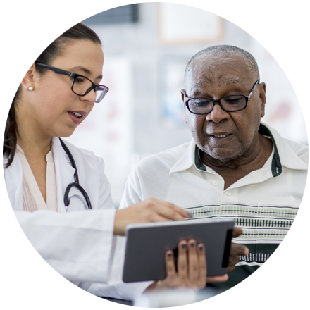 Doctor in white lab coat holding a tablet and explaining results to a patient