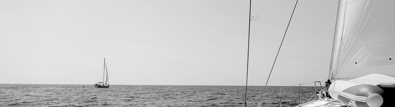 blue background of sailboats on the water on a sunny day 