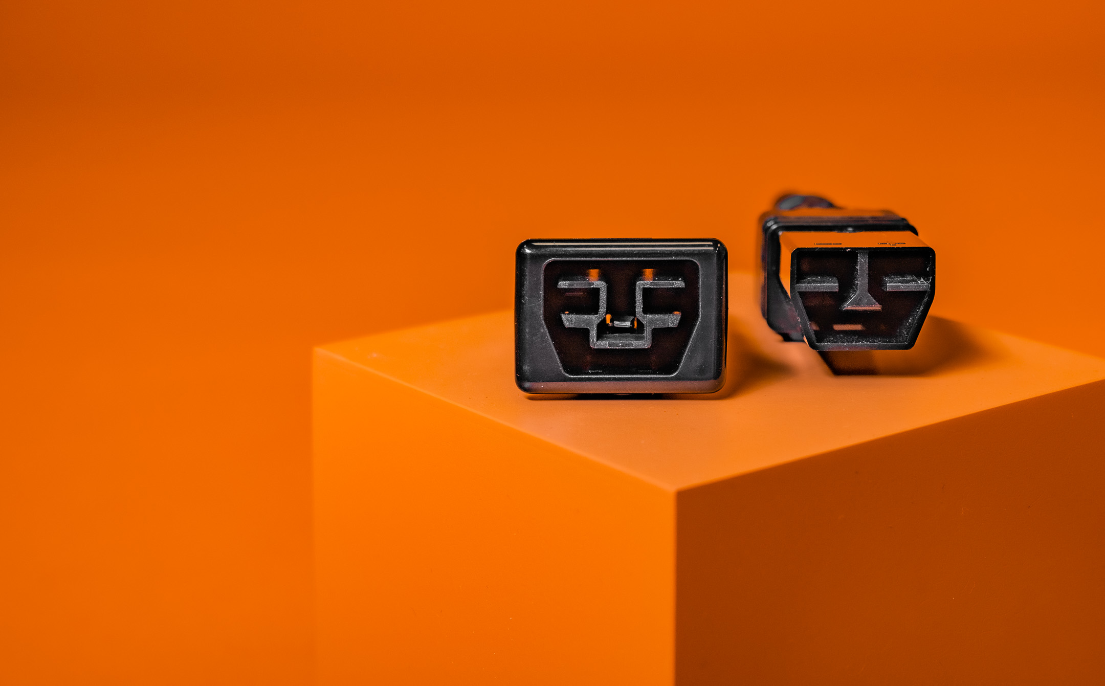 An image of a Saf-D-Grid connector from Anderson Power on an orange background