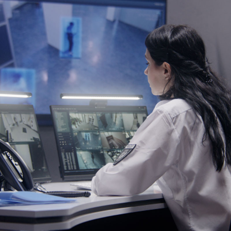 Shot of fitness woman using mobile phone while training on exercise bike at home.