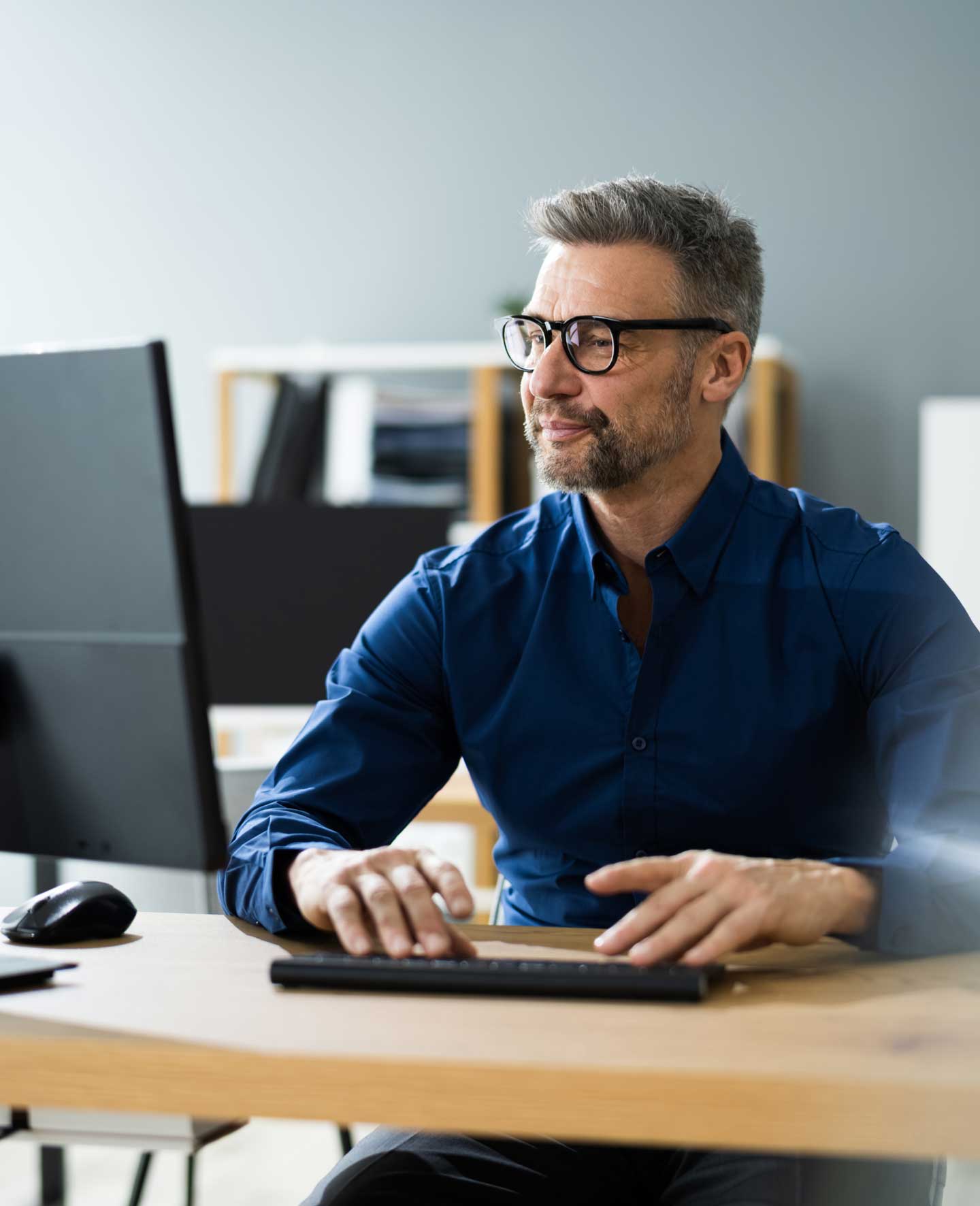 Smiling man working at a computer