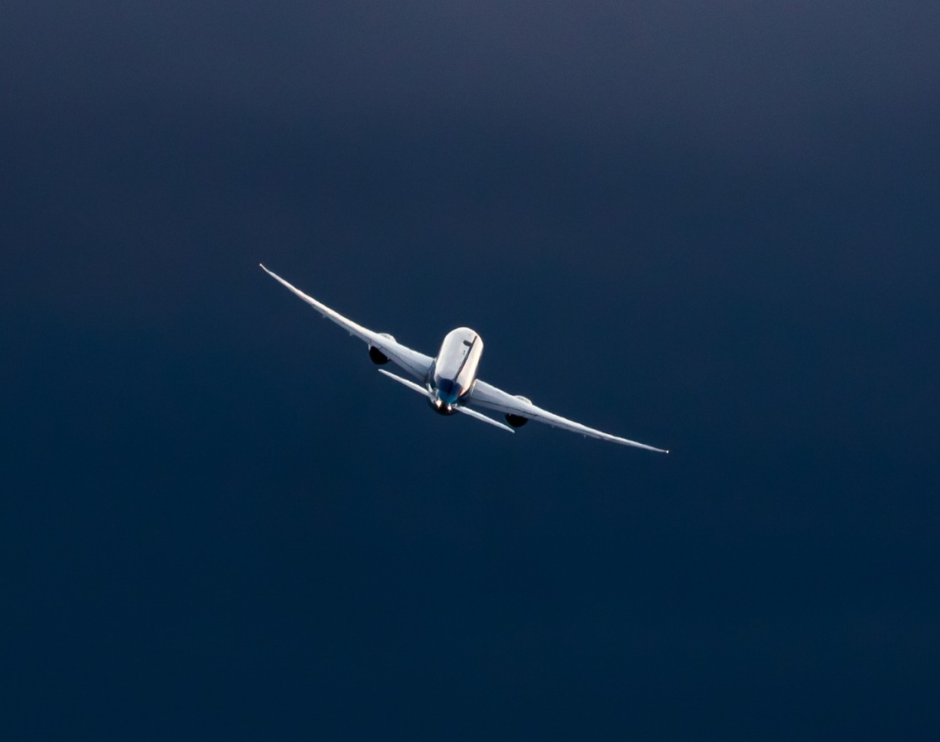 flying airplane from behind on the sky