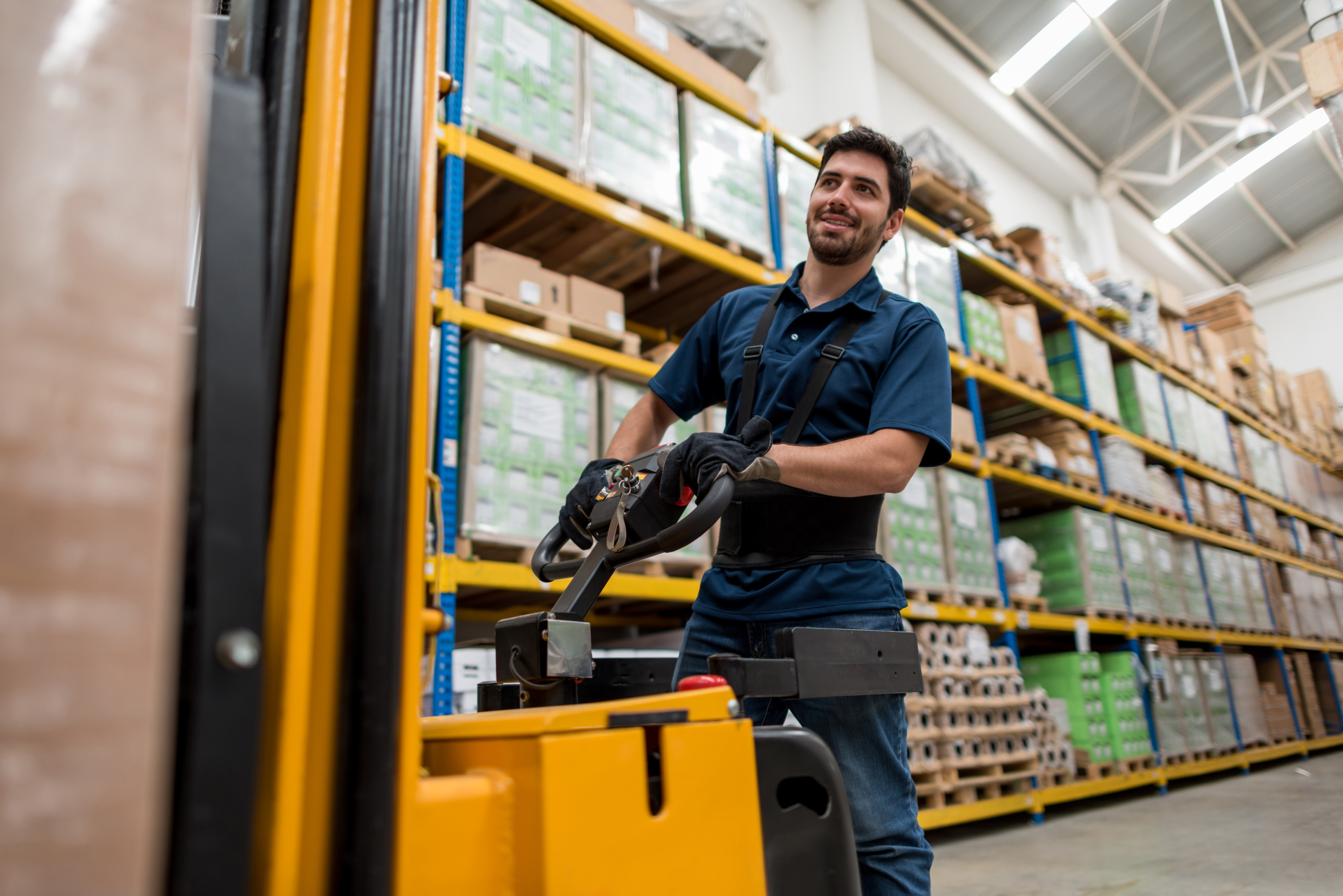 Warehouse worker performing MHE maintenance