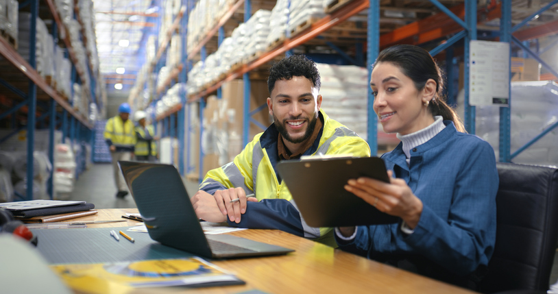 Two warehouse workers a man and a woman working strategically to unlock efficiency