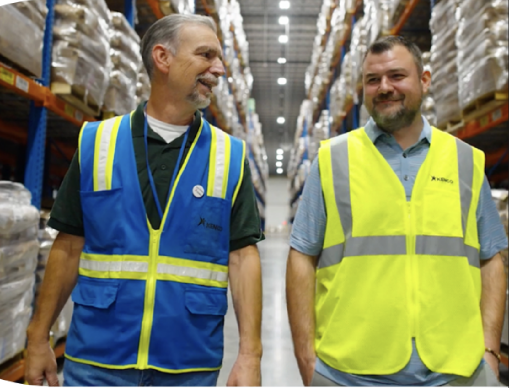 Two warehouse workers walking the warehouse floor 