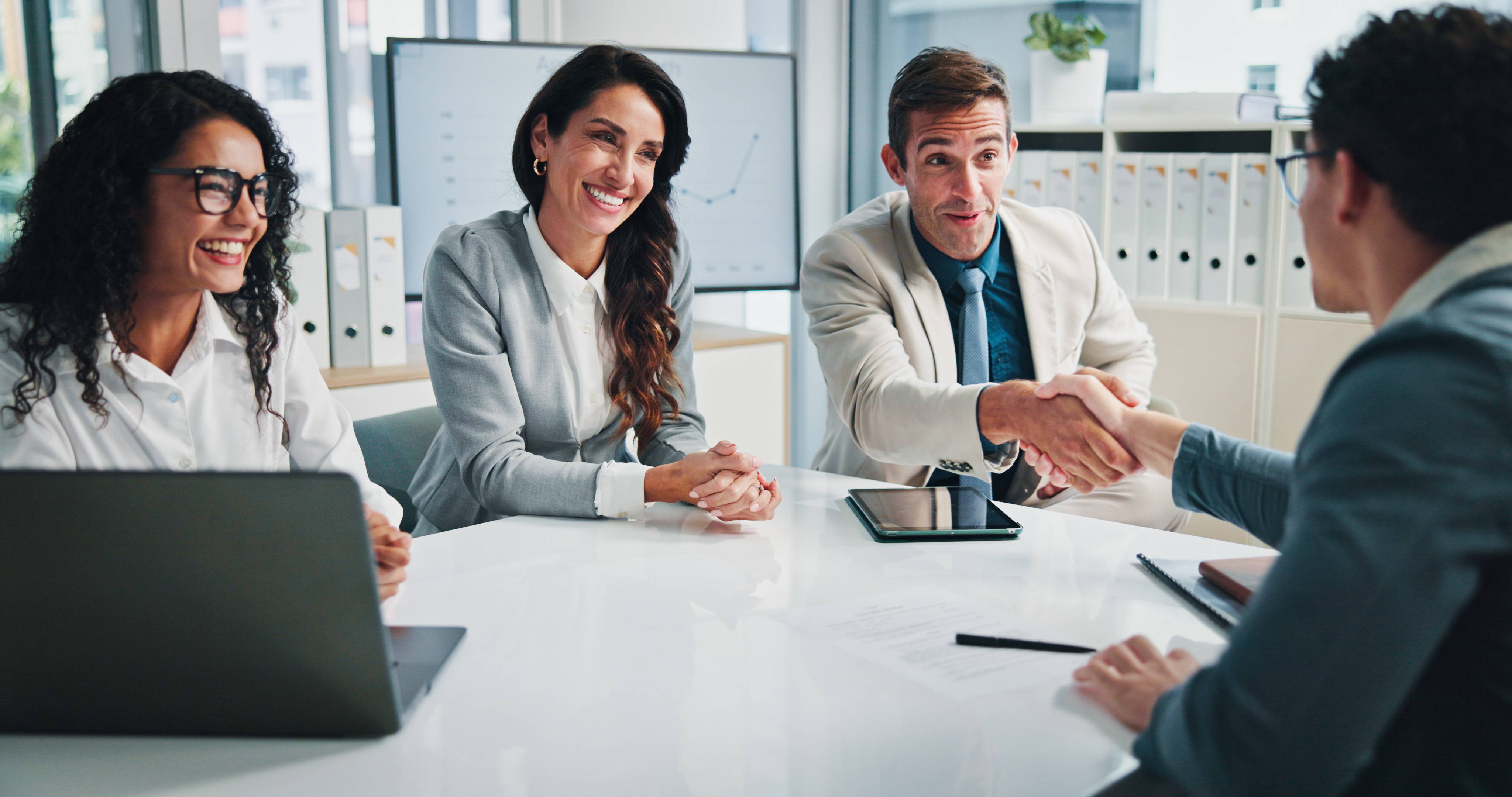 people in finance reaching a deal