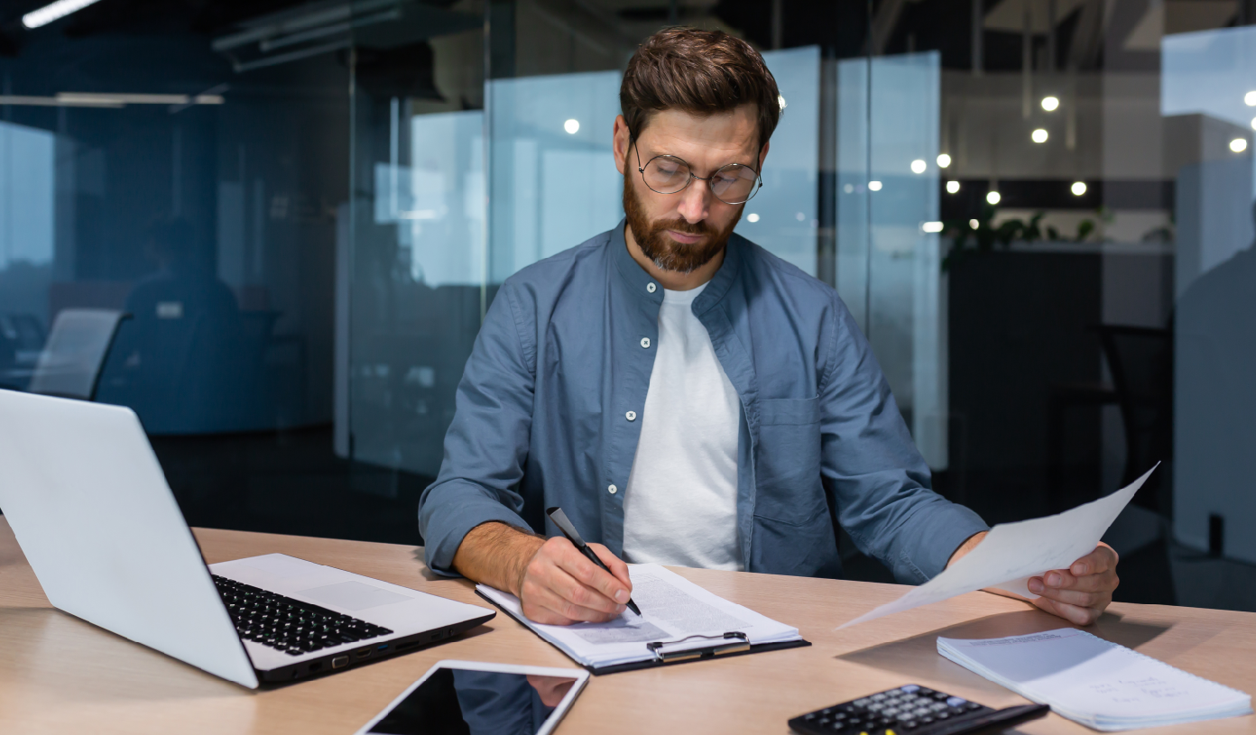 A businessman reviewing documents at a desk