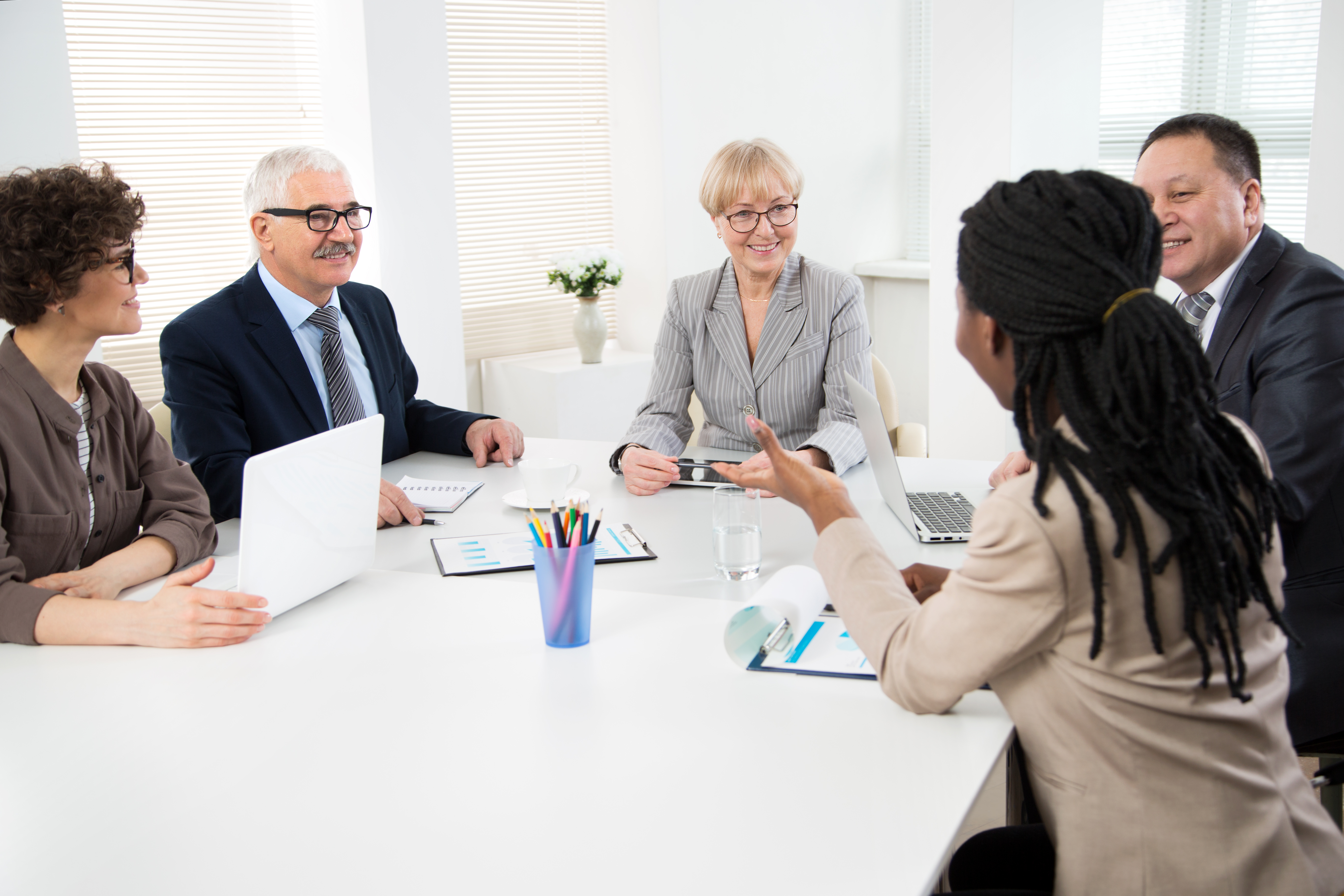 Latin woman working on a laptop doing her budget.