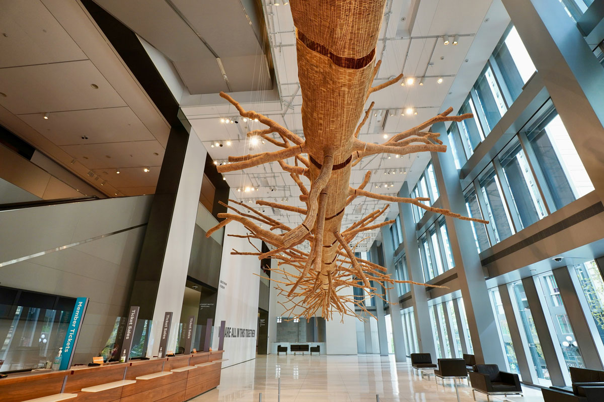 A large sculpture that looks like a tree hangs from the art museum lobby.