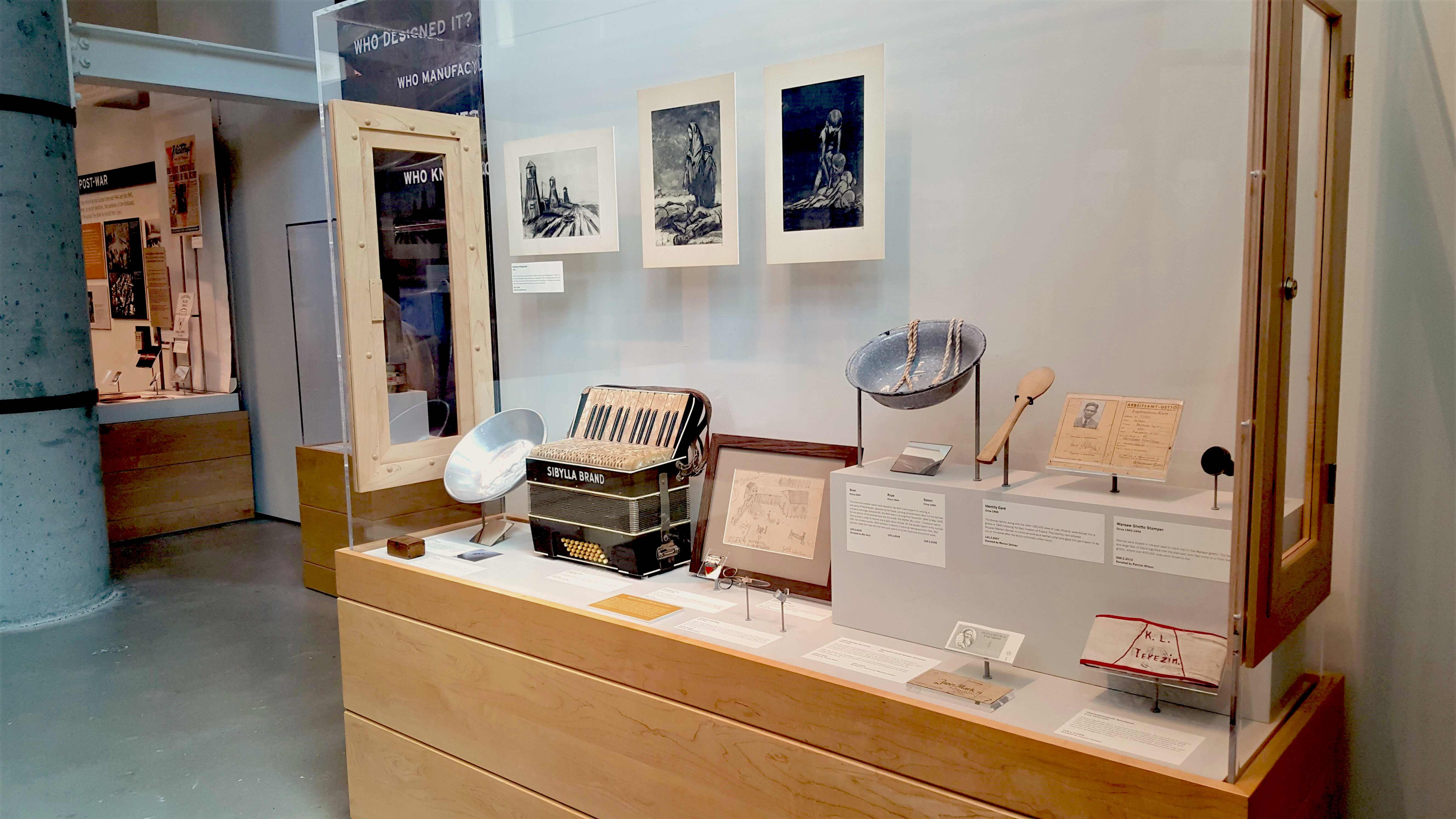 A collection of Holocaust artifacts in a glass case