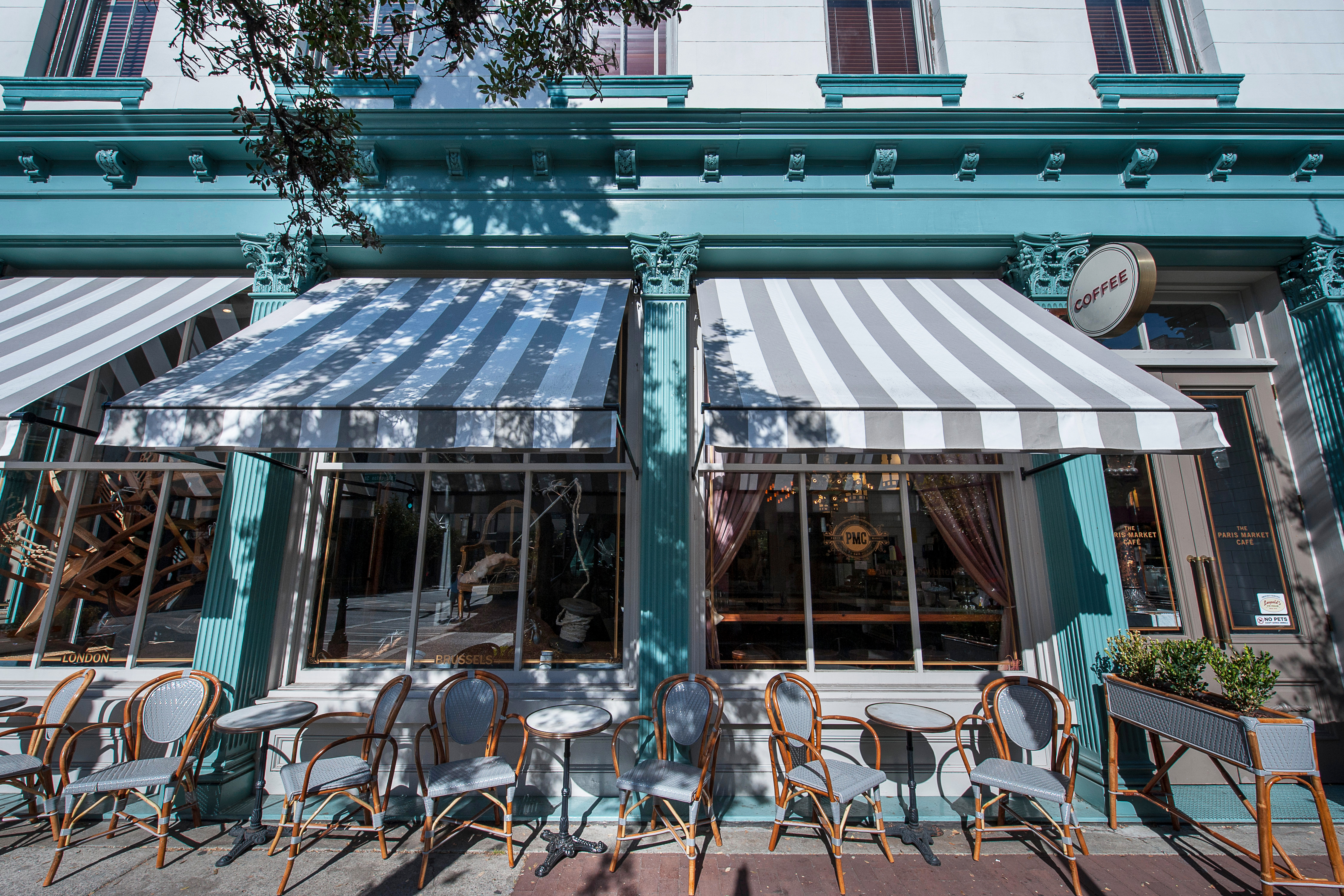 Charming storefront with striped awnings and bistro tables