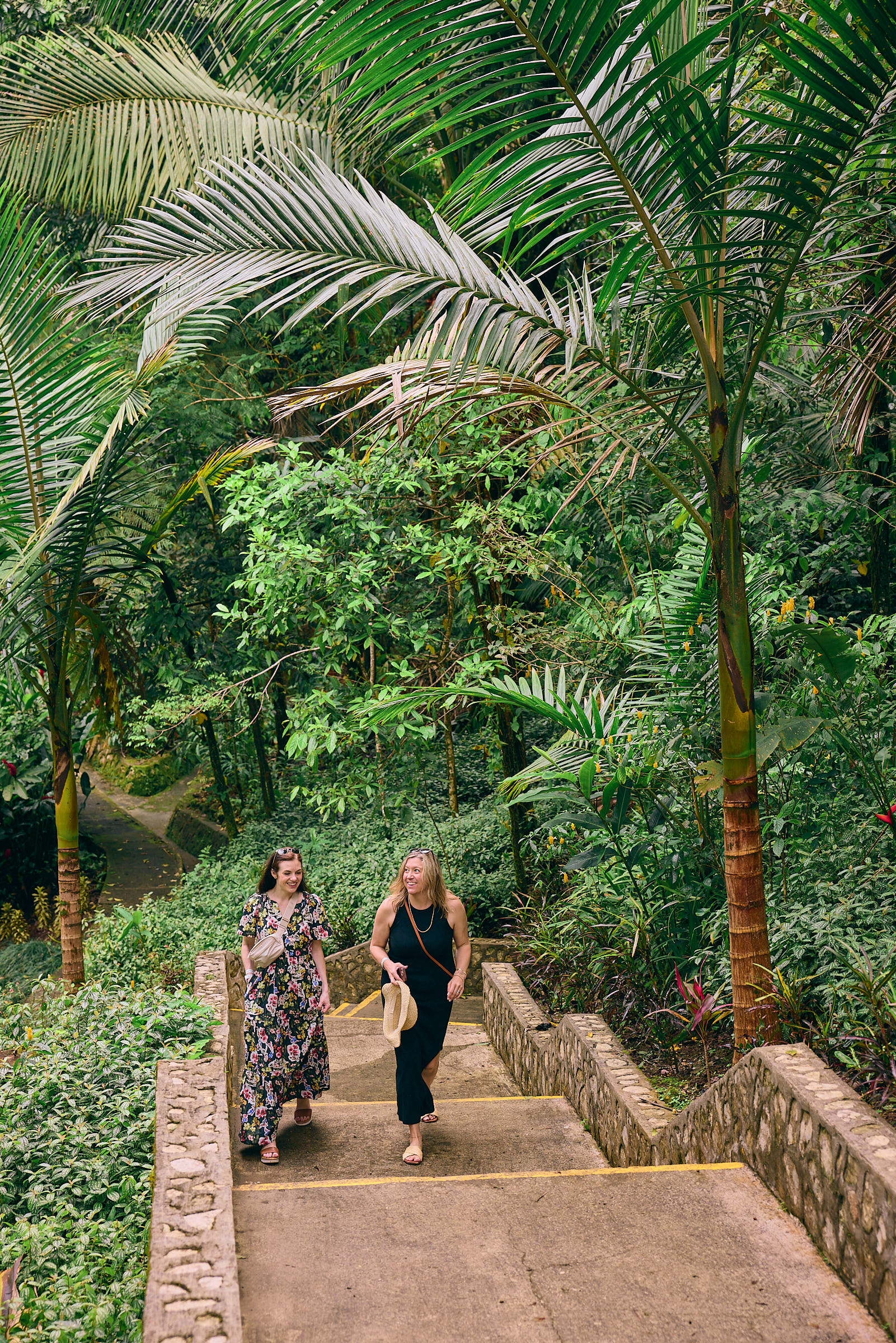Two women walking up a set of stairs in a jungle