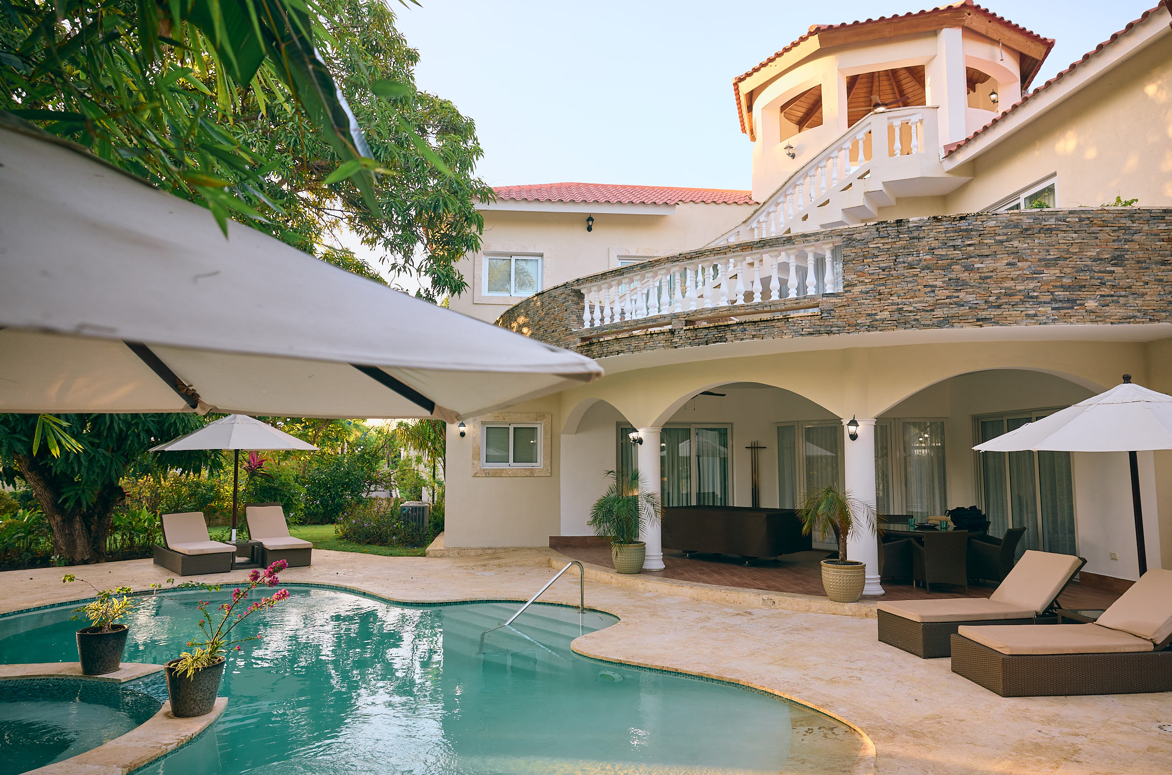 Two-story tropical villa with a backyard pool