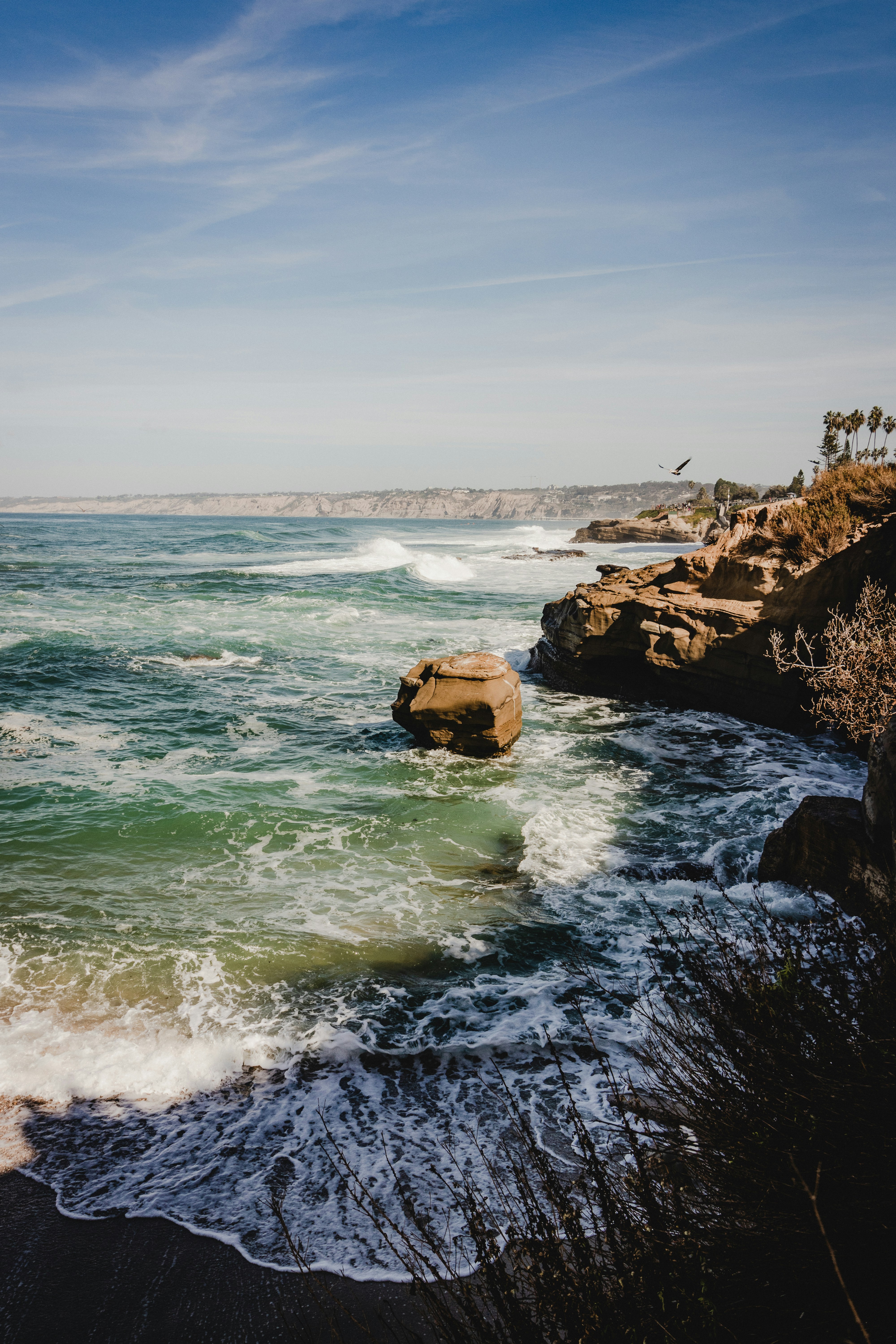Ocean waves crashing against cliffs in San Diego