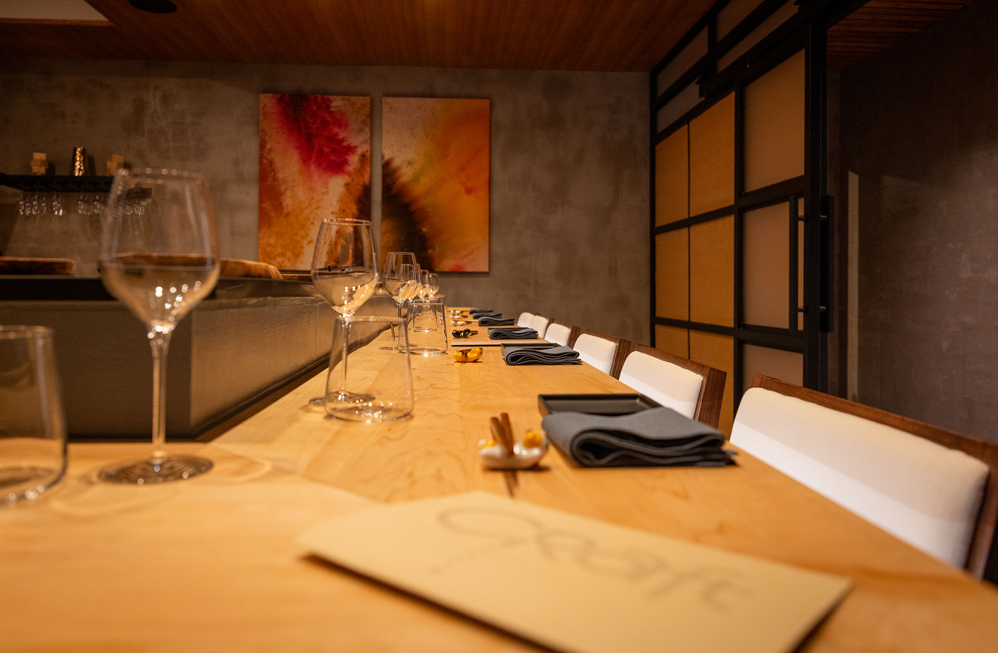Long Hibachi table set with wine glasses in an Asian restaurant