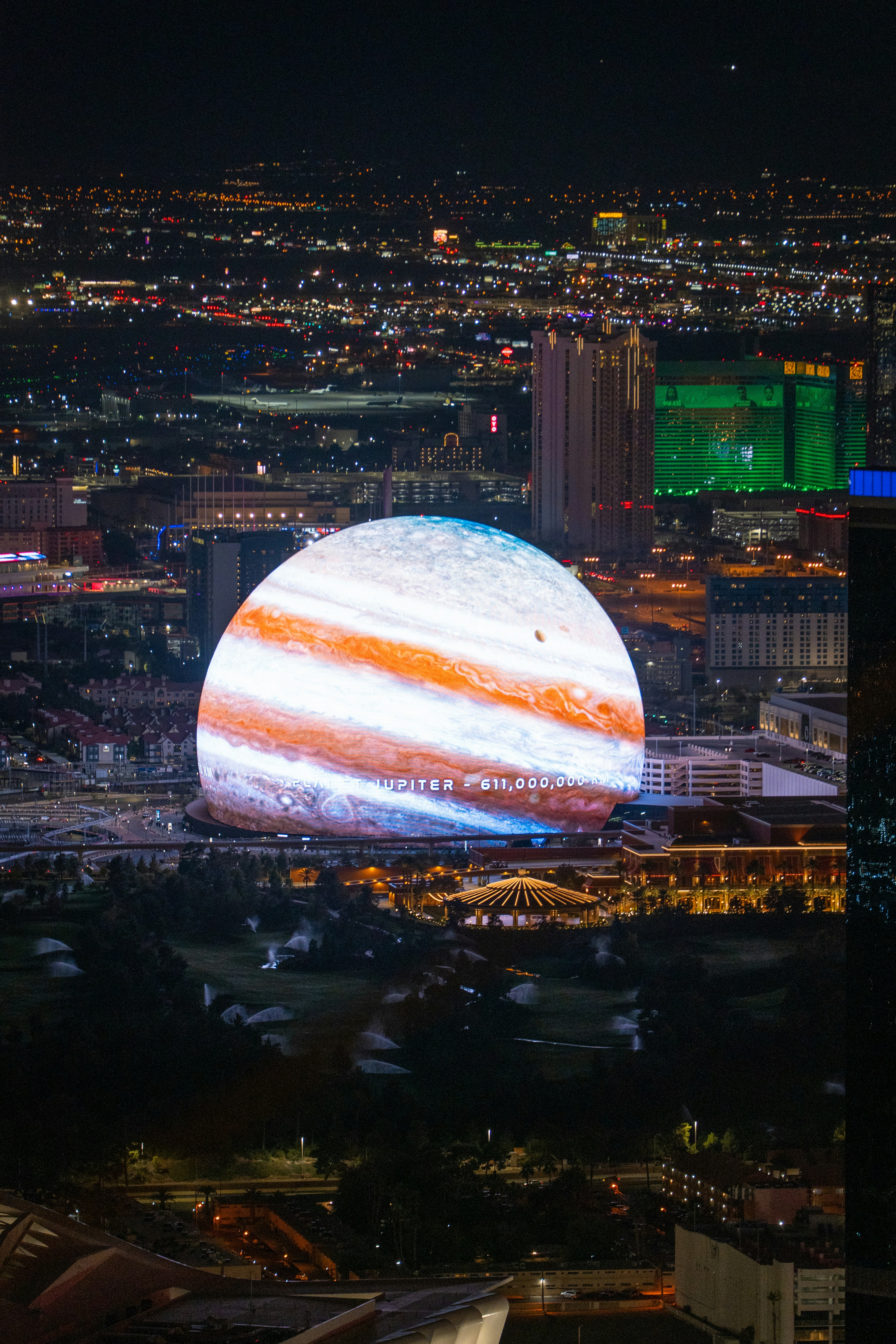 Dome-shaped building with LED screens around the entire surface, making the building look like the planet Jupiter