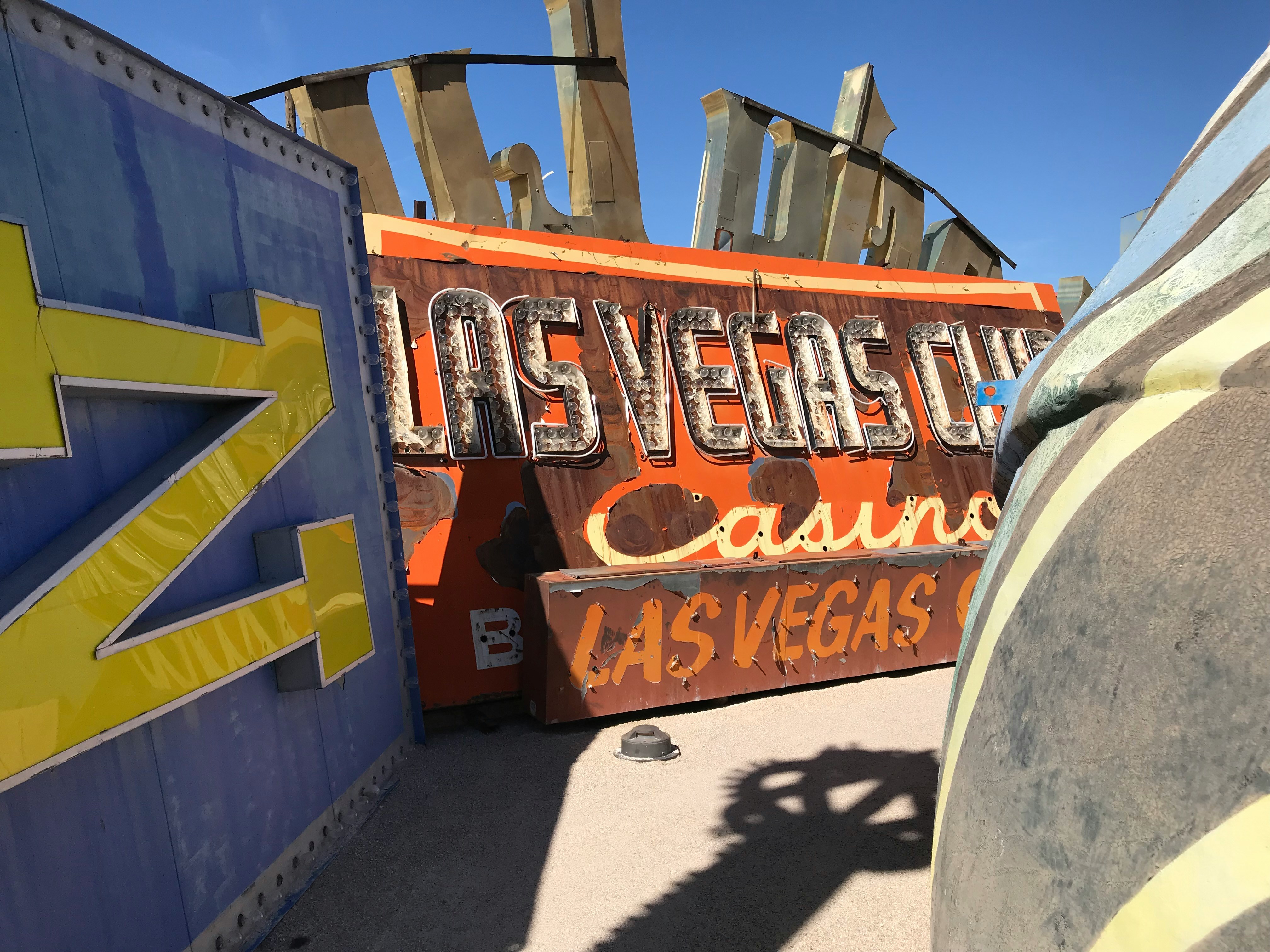 Old neon Las Vegas Casino sign, sitting decommissioned on the desert ground 
