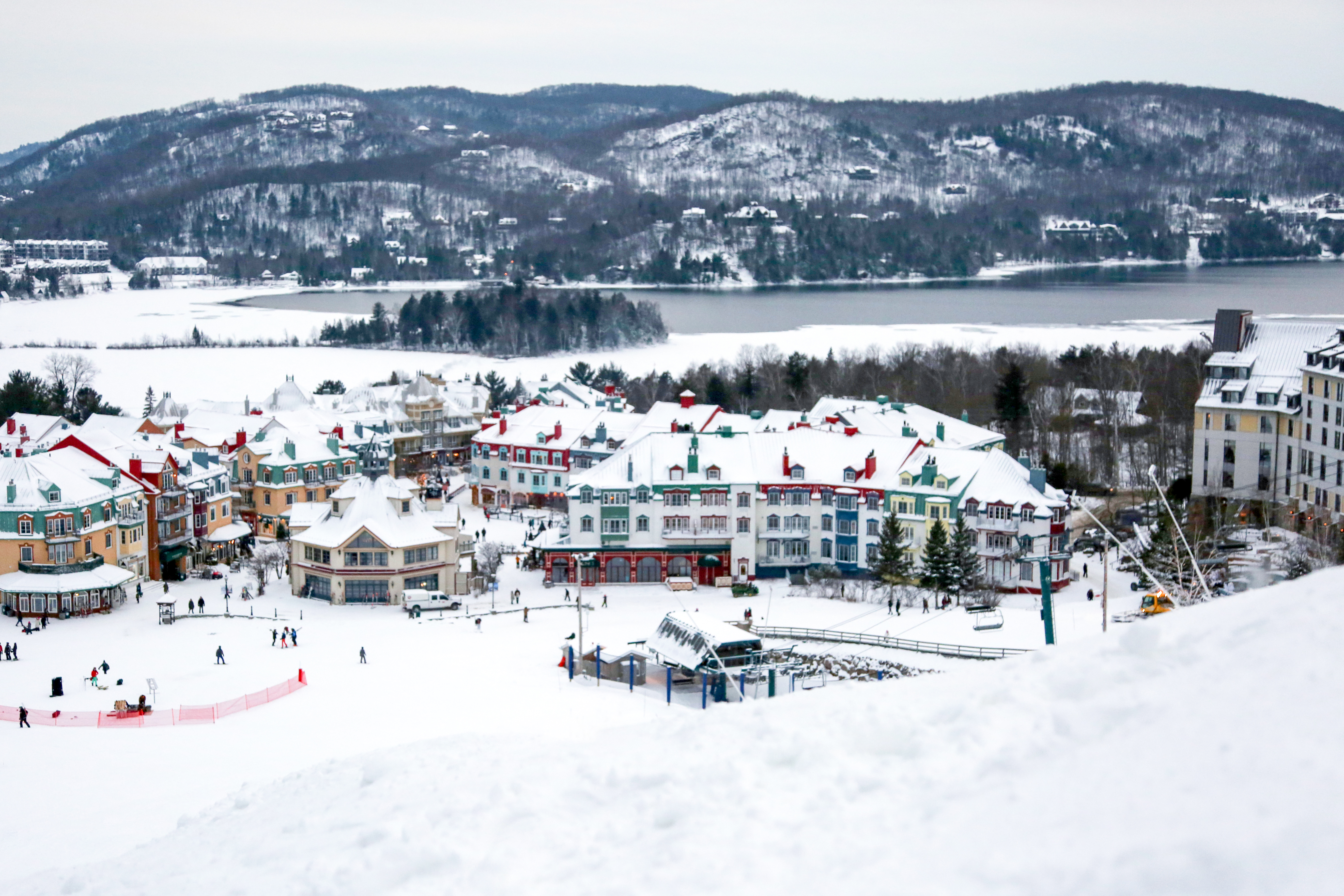 Looking down the mountain at a charming, snowy downtown scene