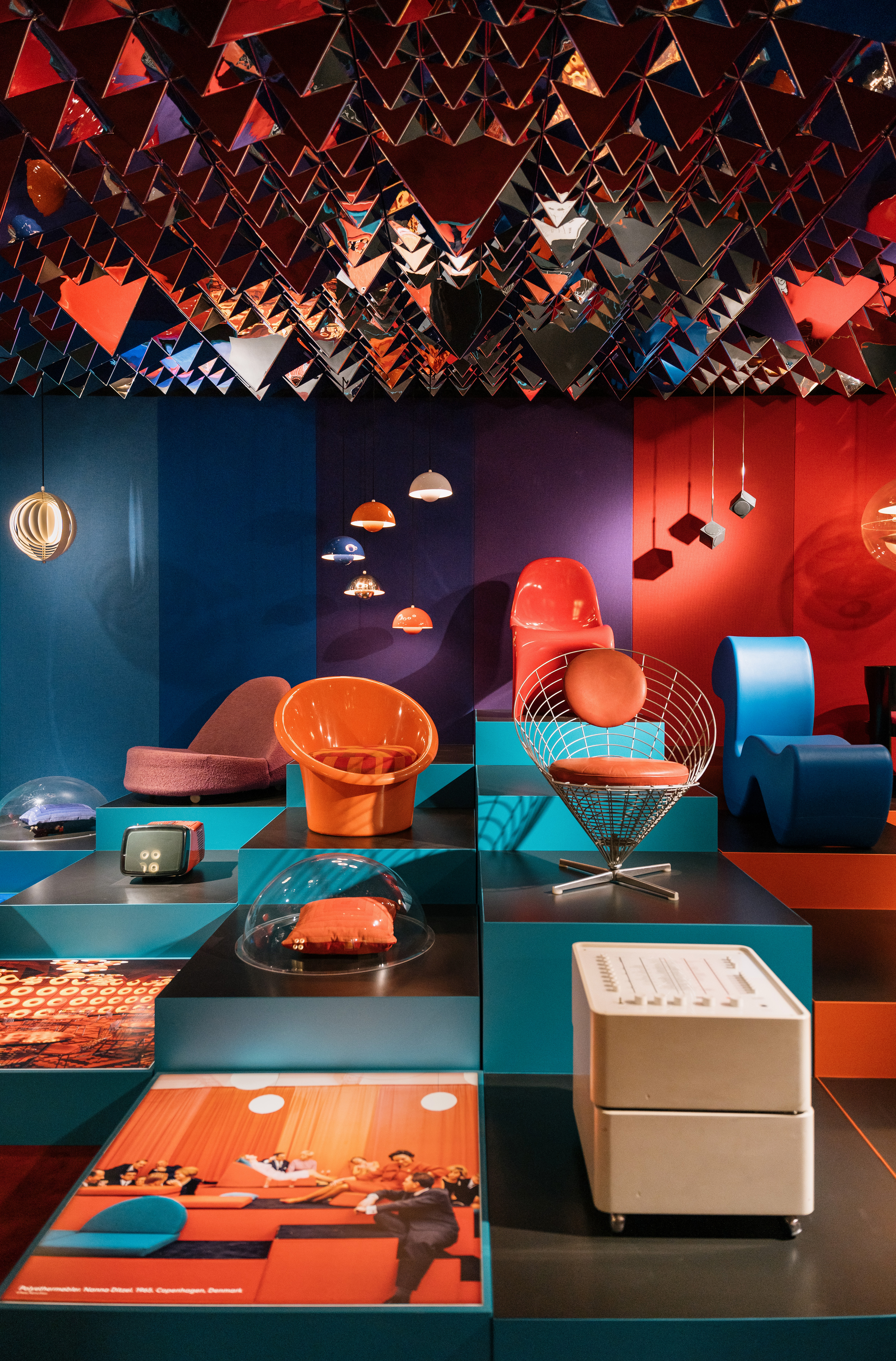 Designmuseum Danmark - Colorful Danish modern chairs on museum pedestals in a funky room