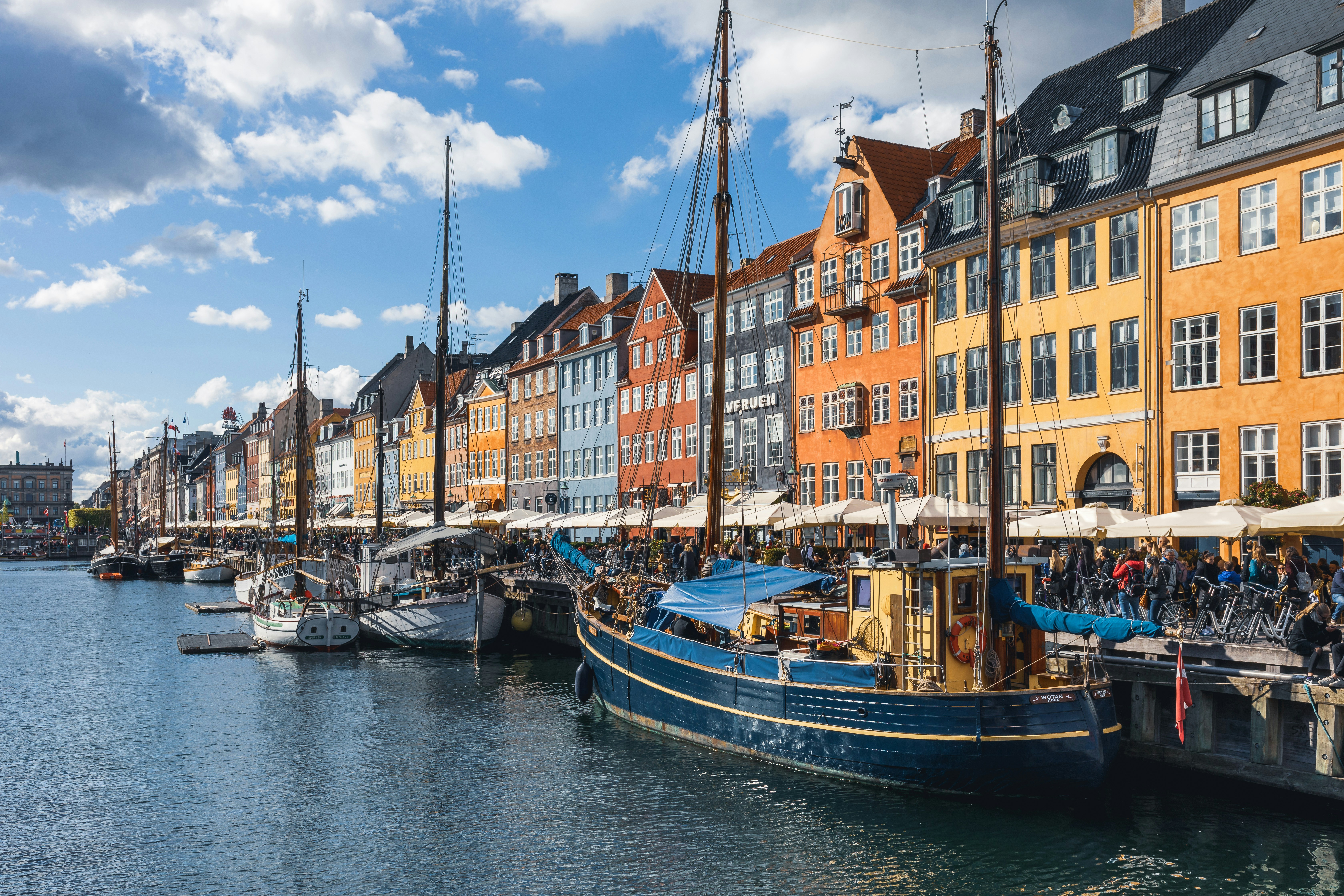 Brightly colored row houses lined up against the water in Copenhagen