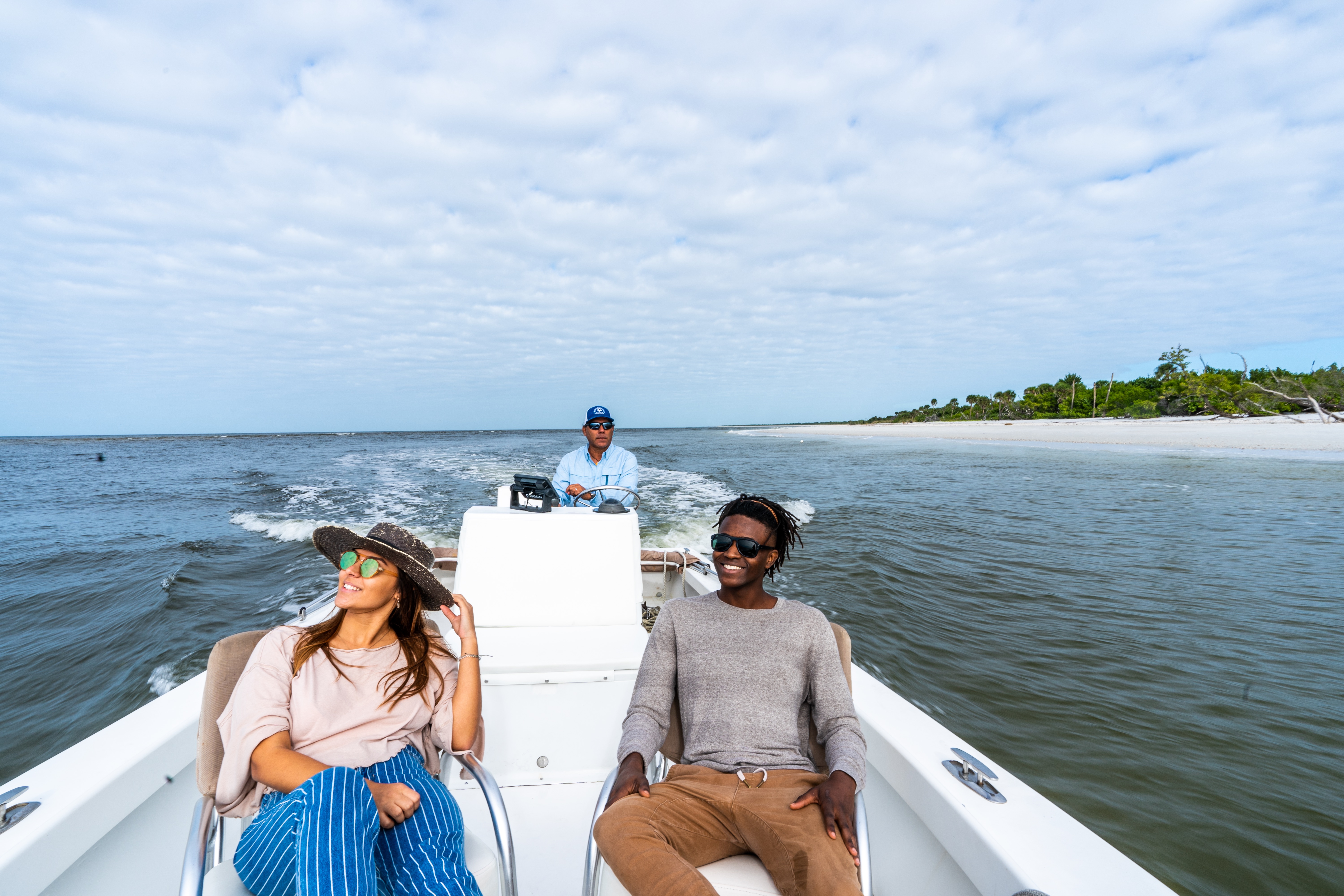 Young woman and man relaxing on a speedboat