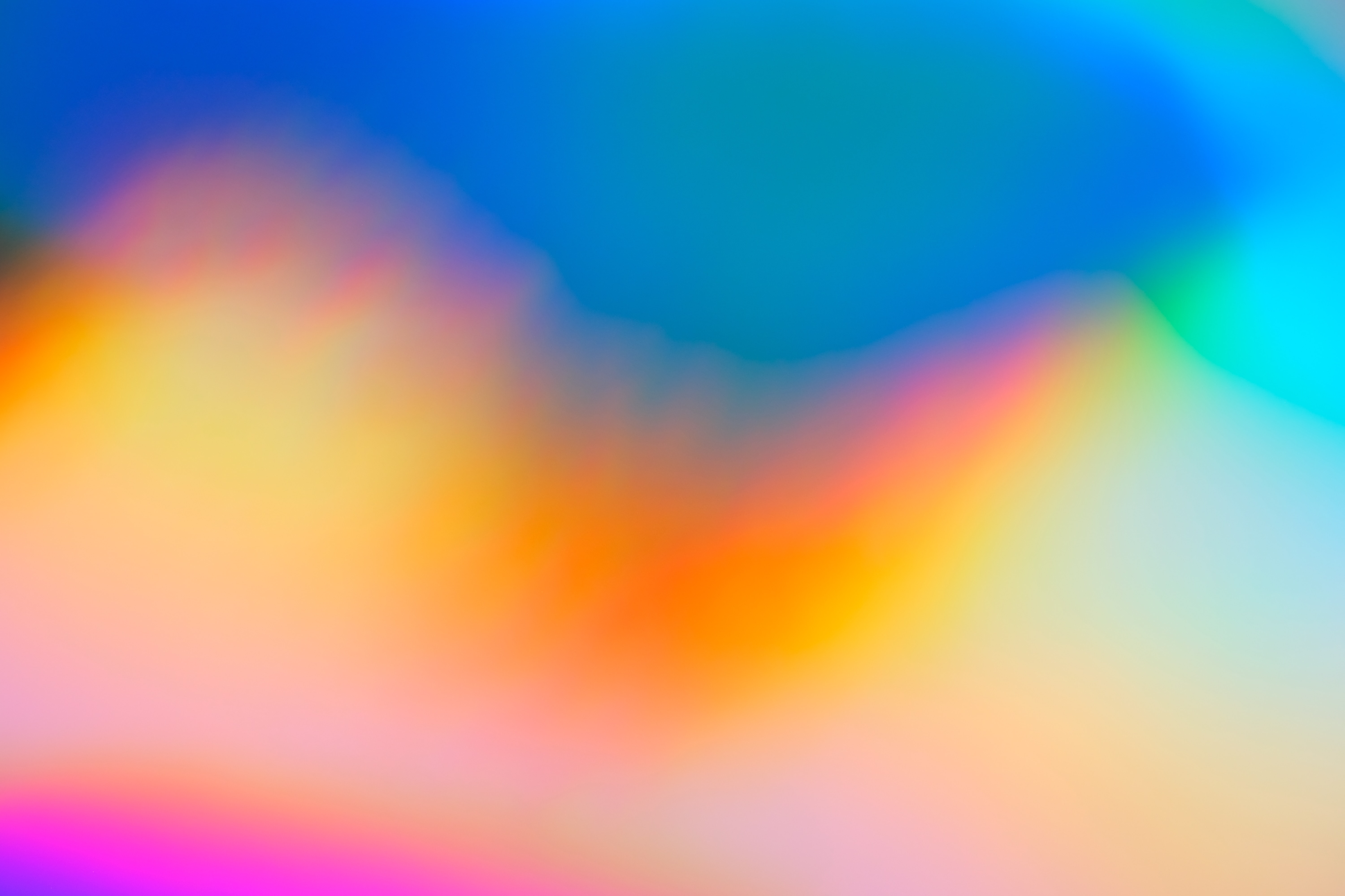 Colorful gradient background with fading royal blue, pink, yellow, green, and light blue hues