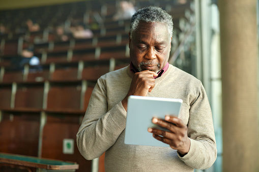 Image of a man looking at a tablet
