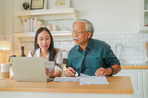 Image of father and daughter preparing budget