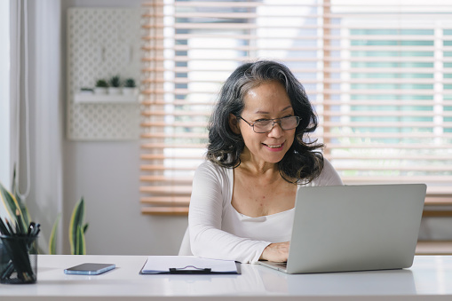 Image of a women looking at a laptop