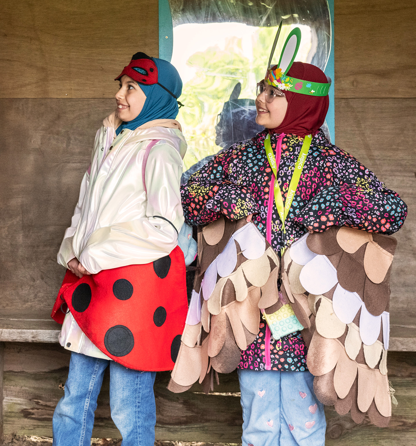 Children dressed up as a ladybird and an owl while laughing