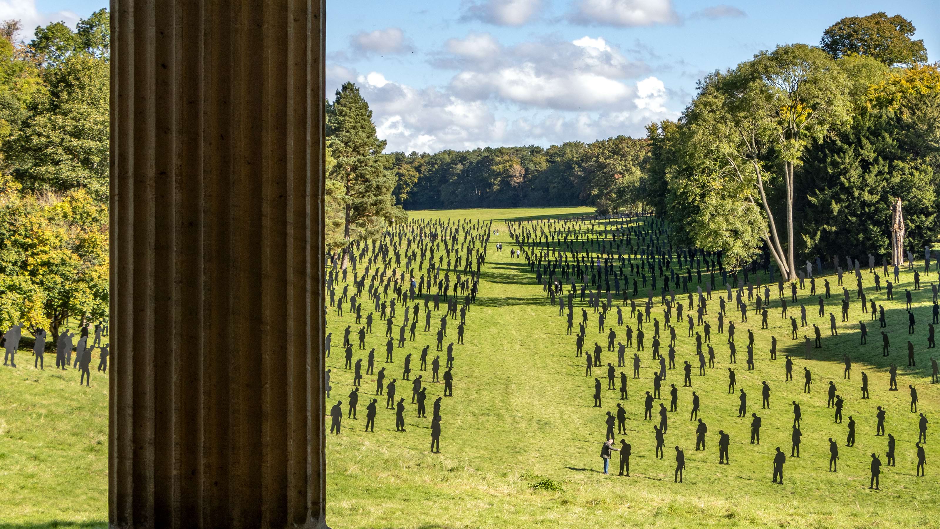 View through two trees of 1,475 silhouettes of Second World War military personnel