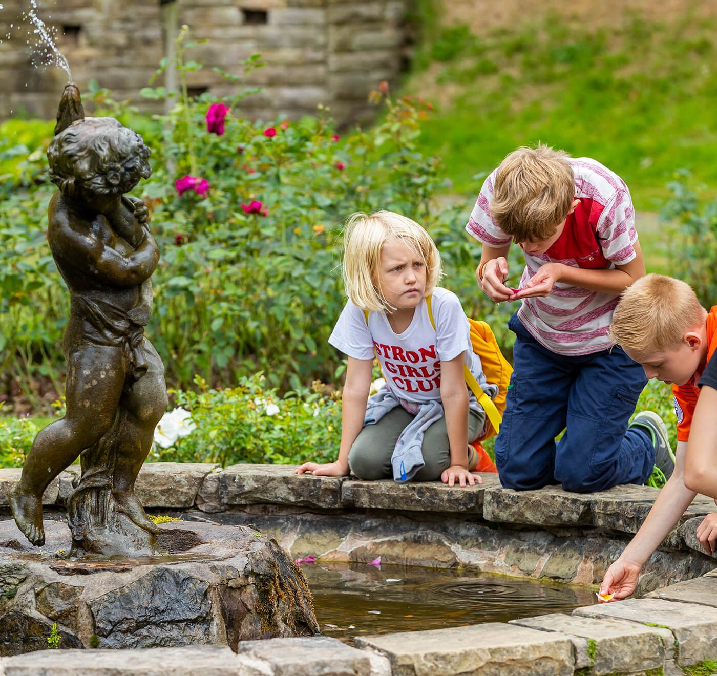 Children looking into the pool in the Rose Garden at Lyme Park, Cheshire