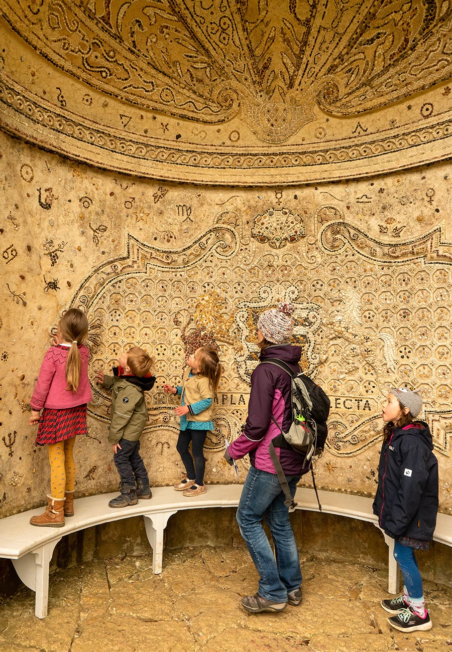 Family look at the detail in the Pebble Alcove at Stowe, Buckinghamshire