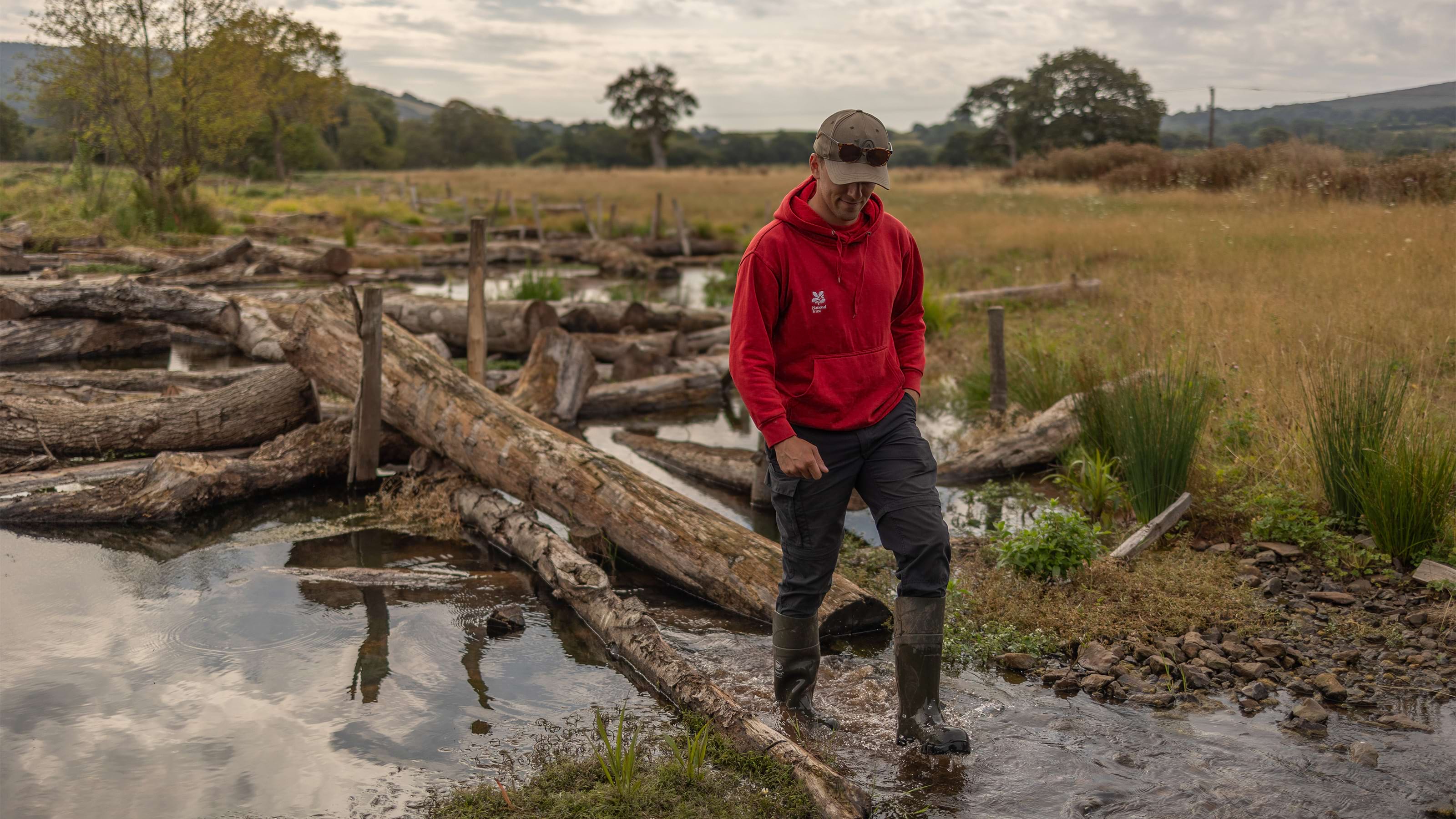 National Trust ranger monitoring the grounds at Holnicote one year on from the completion of the river restoration project, Somerset