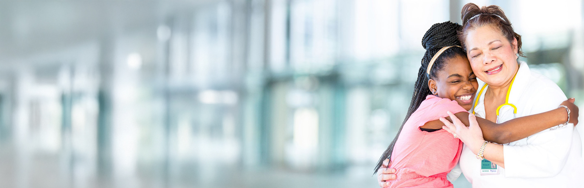 Nemours Clinician embracing child.