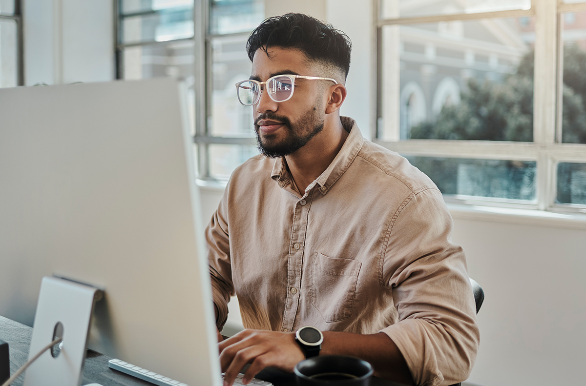 Man sitting and working on his desktop