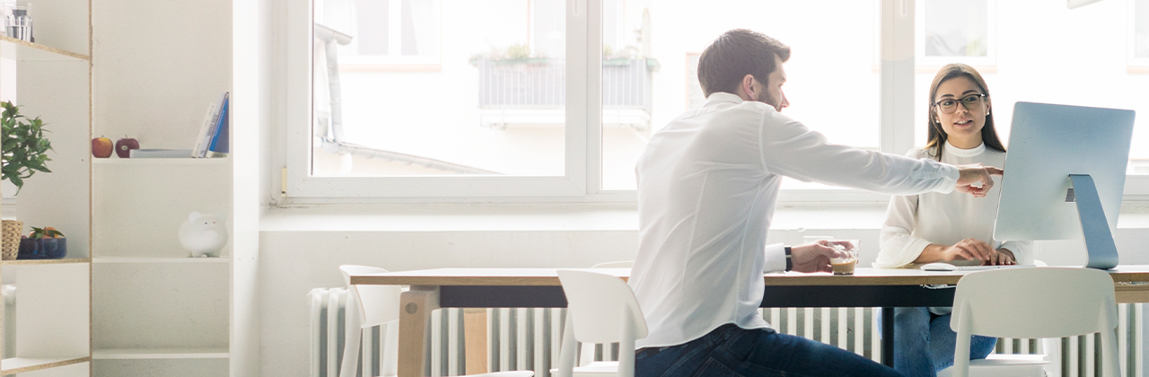 Man and woman looking at computer screen.