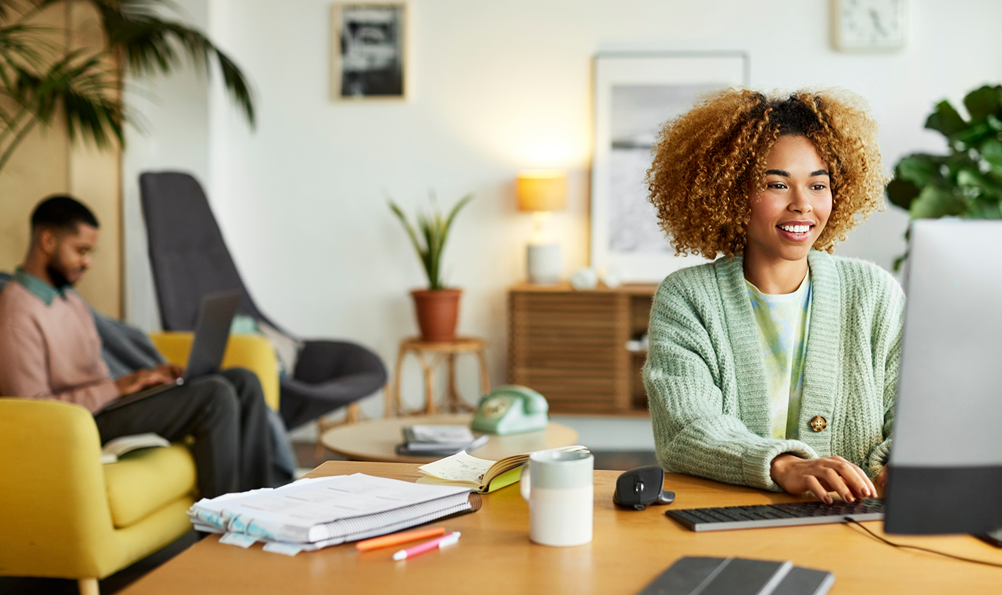 Woman using computer in a living room.
