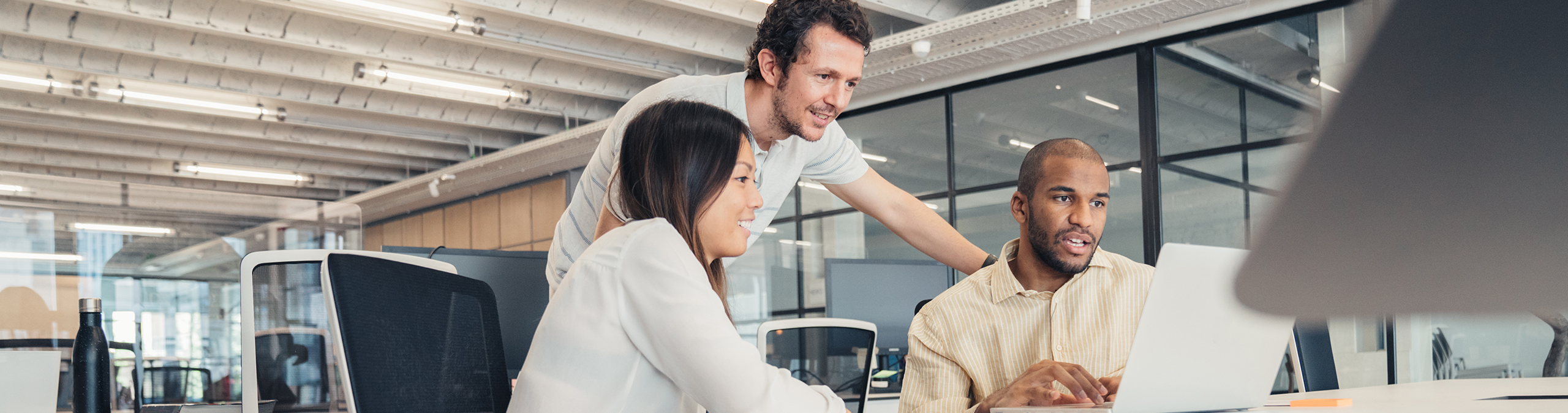 Coworkers looking at computer screen